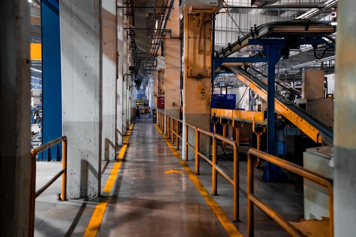 Automobile factory floor with machinery and vehicles