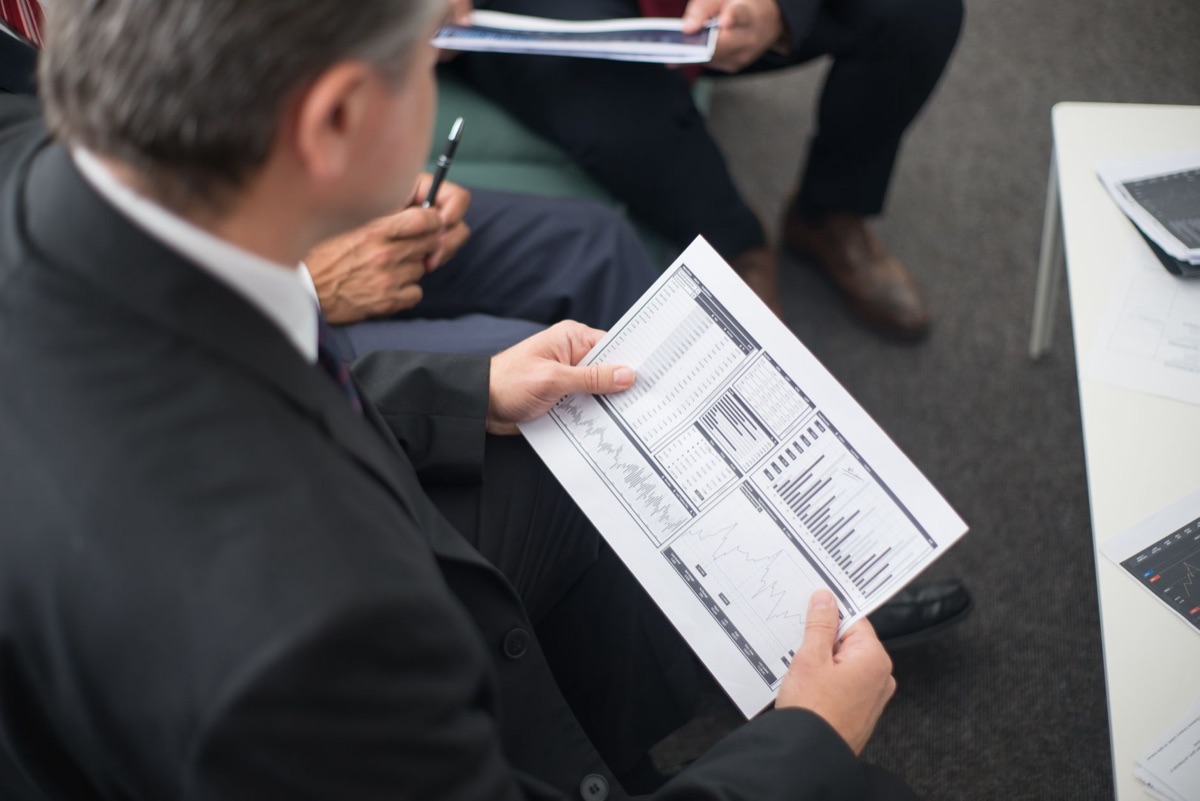 Government officials reviewing supply chain data