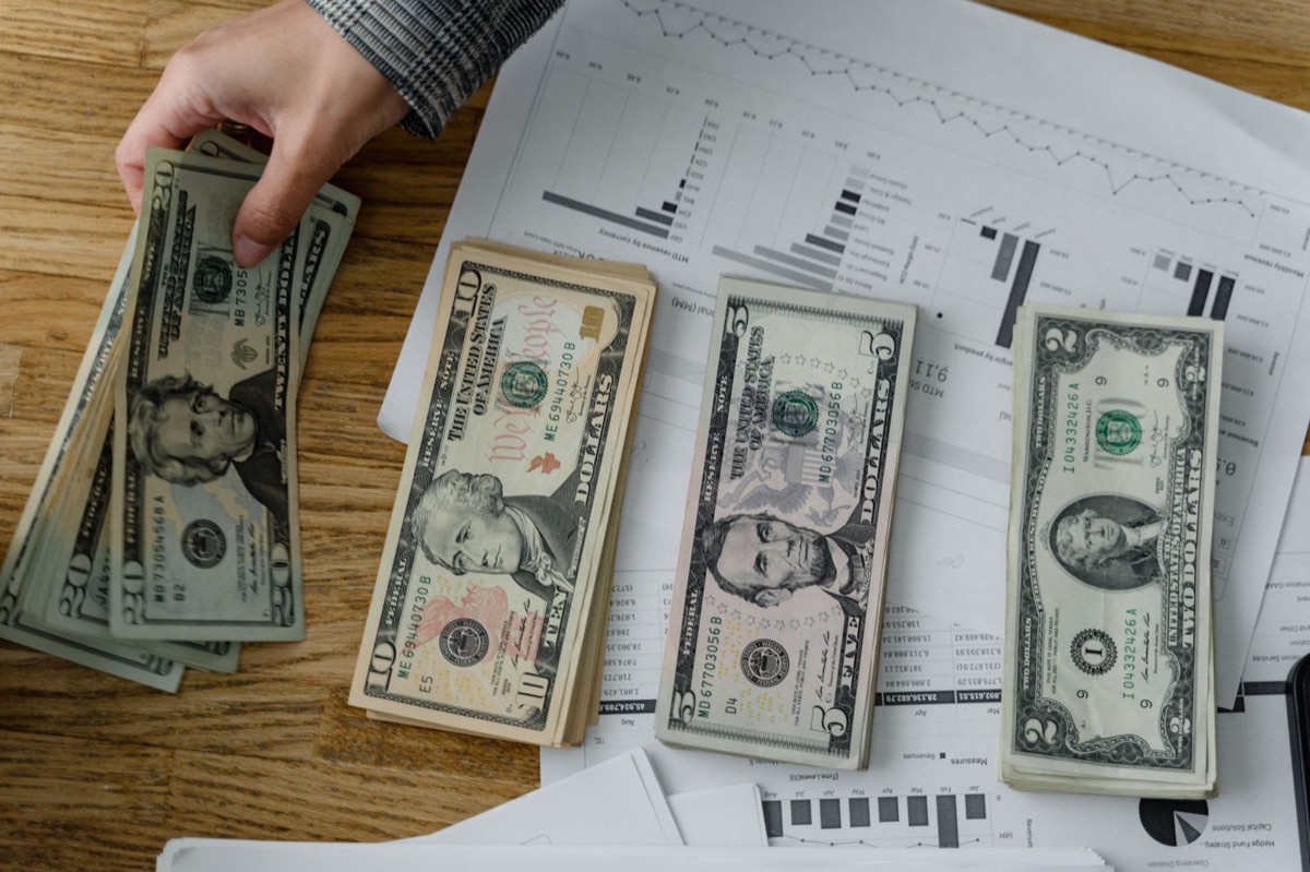 Close-up of US currency and financial growth charts reflecting inflation trends.